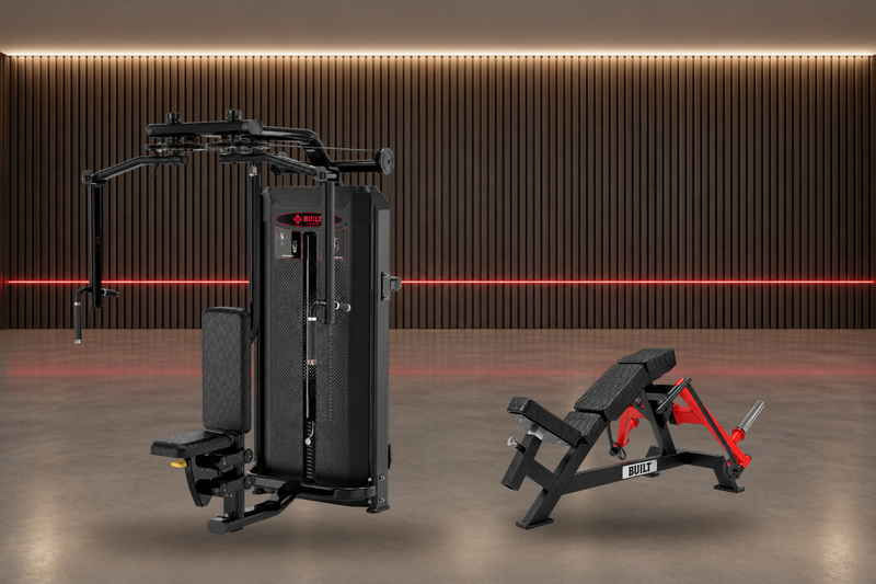 BUILT Strength Fractal Series Pec Fly / Rear Delt and BUILT Strength OG Series Deep Pec Fly in a strength studio with a dark wood slat wall and a red light line